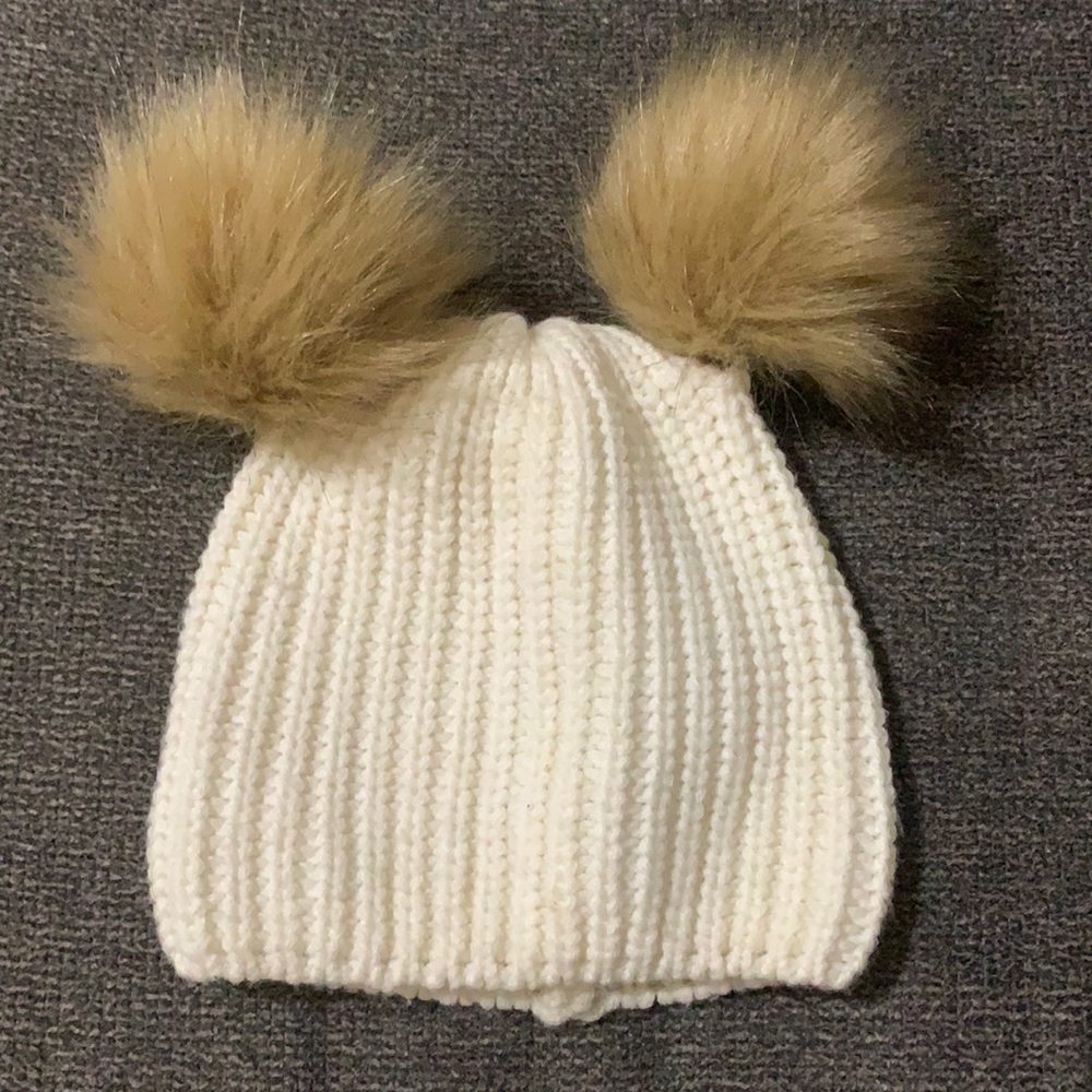 These is a girl winter hat with a cute feather balls on the top. It’s not new!